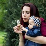best degrees for moms going back to school Photo by Iuliyan Metodiev: https://www.pexels.com/photo/woman-holding-baby-while-blowing-dandelion-2224959/