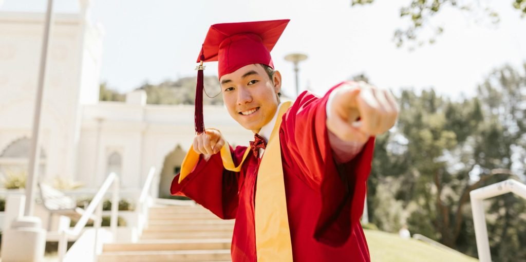 man in red gown earns his 2 year degree