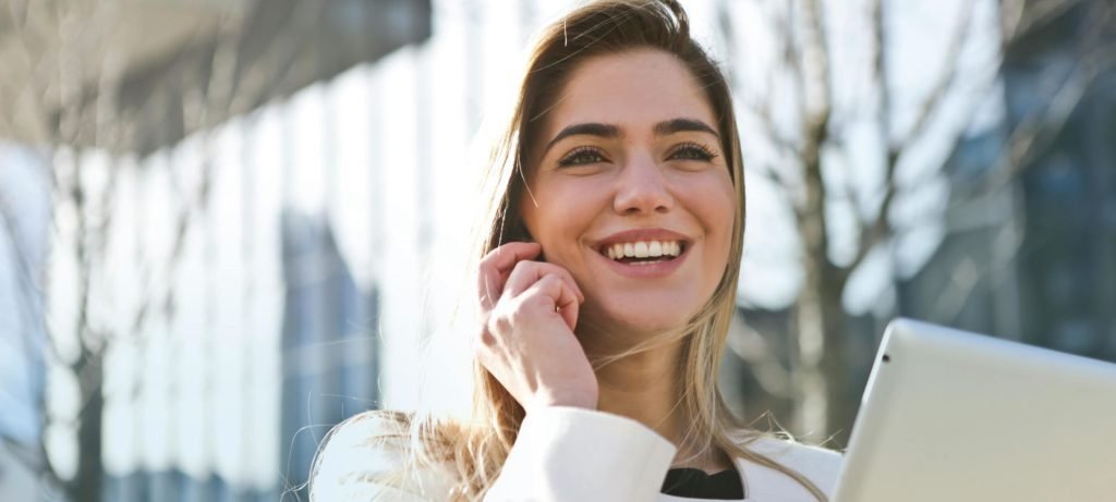 college girl talking on the phone while walking to class